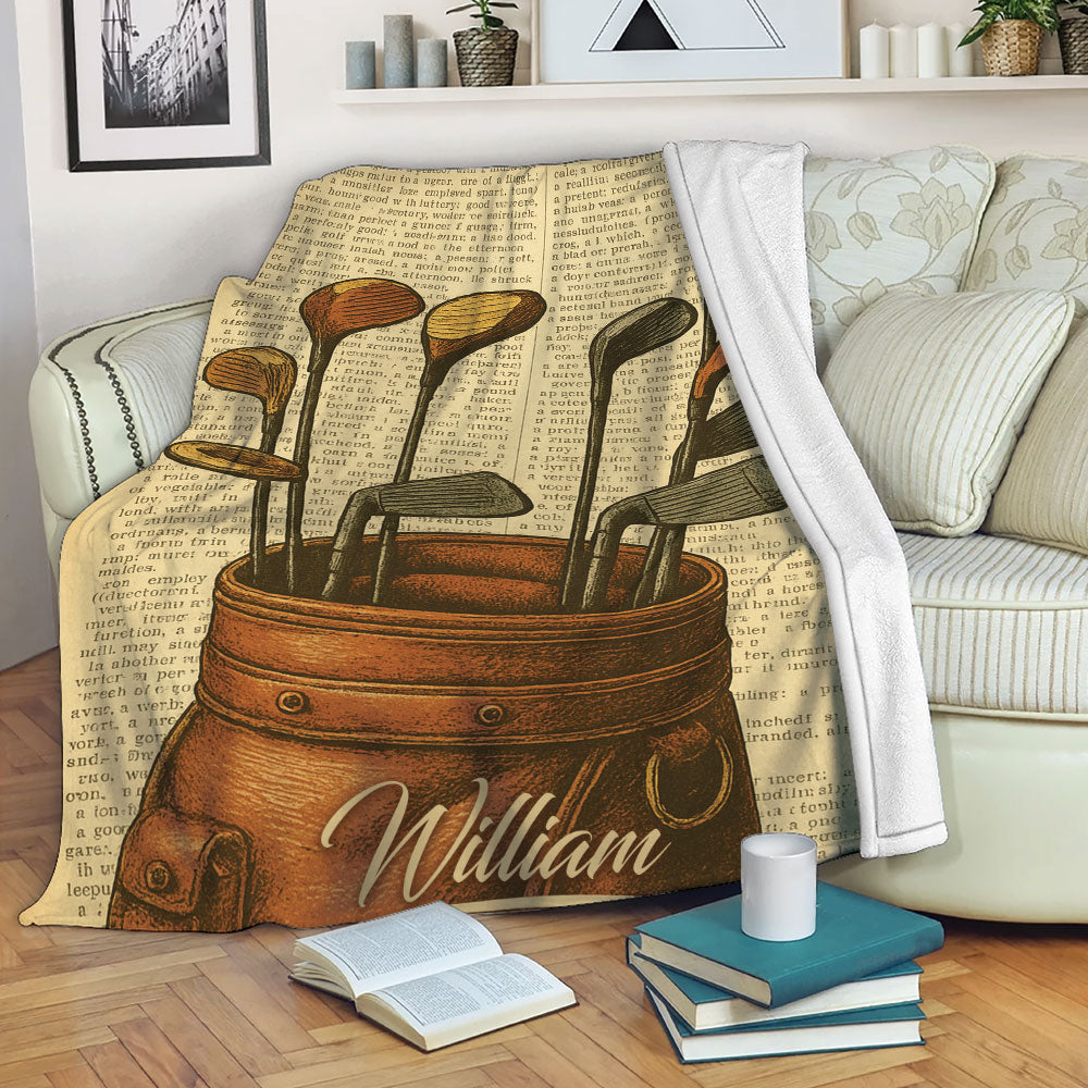 Golf blanket draped over a sofa, showing vintage golf clubs and bag artwork in a cozy living room