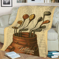Vintage golf throw blanket displayed on a sofa with illustrated clubs, golf bag, and antique book-page background