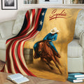 Western barrel racing blanket draped over a sofa with horse, rider, barrel, and flag design