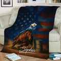 Patriotic barrel racing throw blanket displayed on a sofa with horse, rider, and barrel artwork