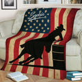 Barrel racing blanket displayed on a couch with a mounted cowgirl silhouette and vintage American flag design