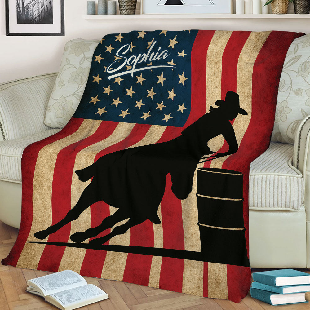 Barrel racing blanket displayed on a couch with a mounted cowgirl silhouette and vintage American flag design