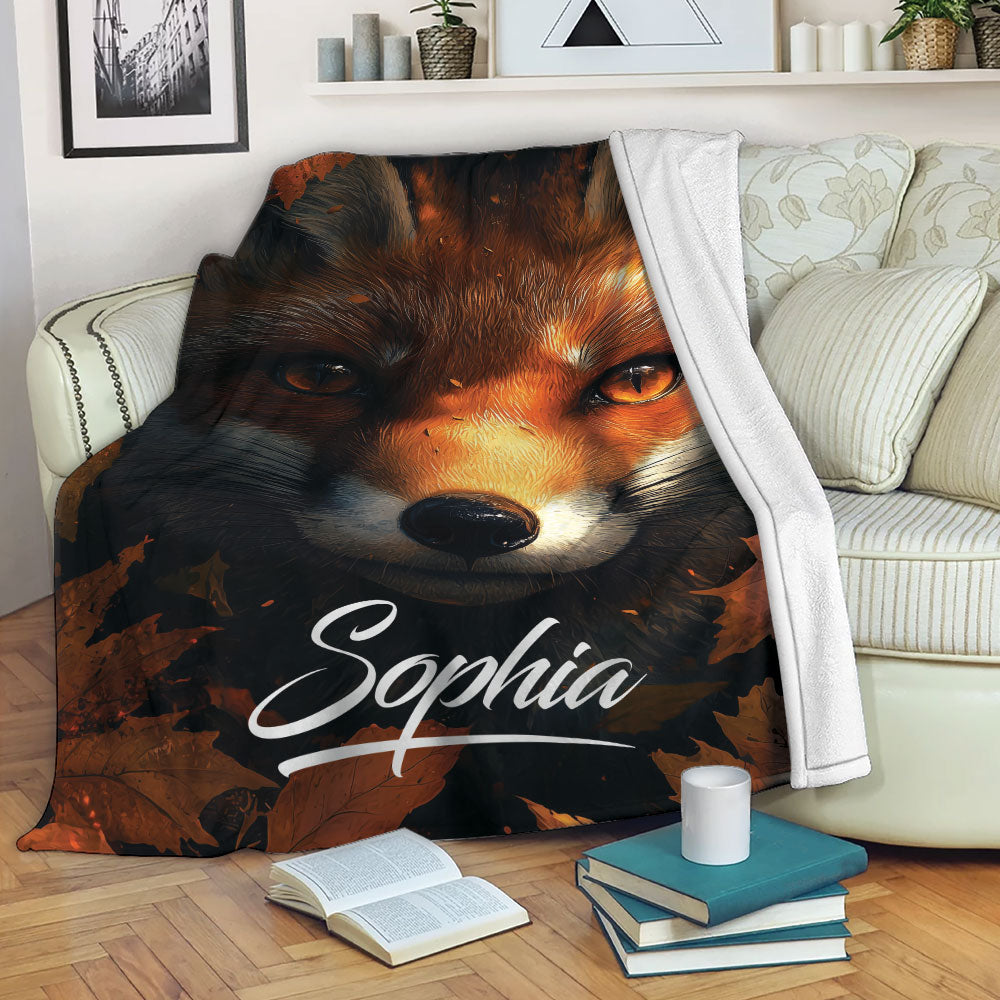 Fox throw blanket displayed on a sofa with autumn woodland artwork in a cozy living room