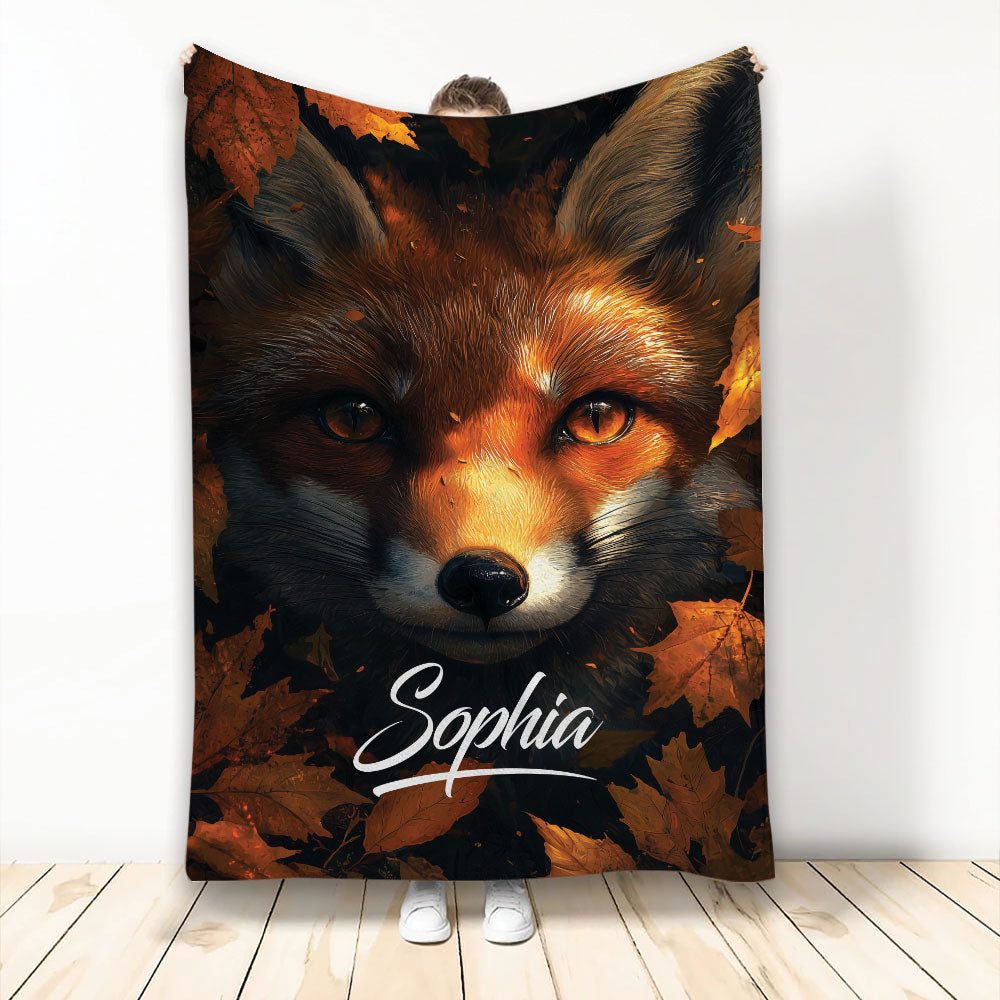 Fox throw blanket featuring a close-up wildlife portrait surrounded by rich autumn leaves