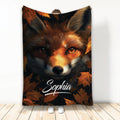 Fox throw blanket featuring a close-up wildlife portrait surrounded by rich autumn leaves