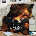 Autumn fox throw blanket draped over a sofa with detailed wildlife artwork and fall leaves