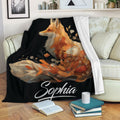Fox throw blanket draped over a sofa, featuring orange botanical artwork on a black background