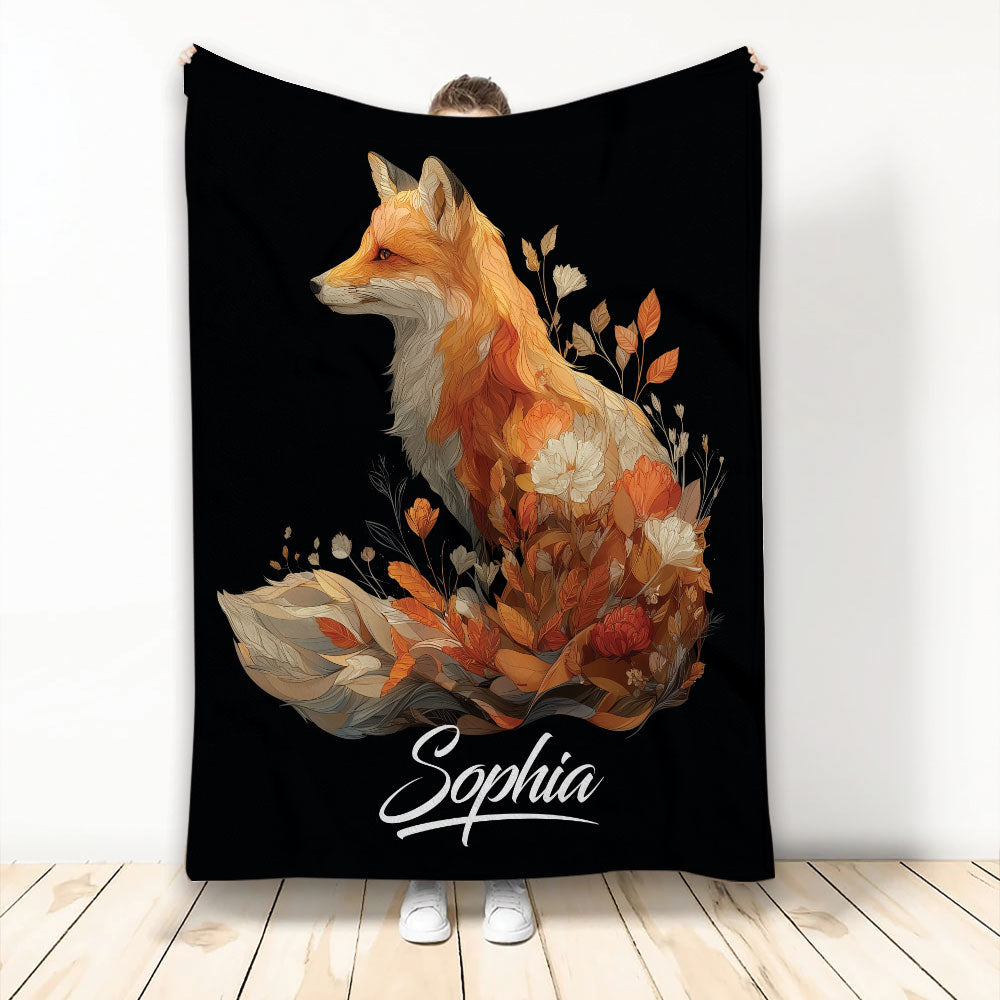 Custom fox throw blanket with an orange fox surrounded by autumn flowers and foliage on a black background