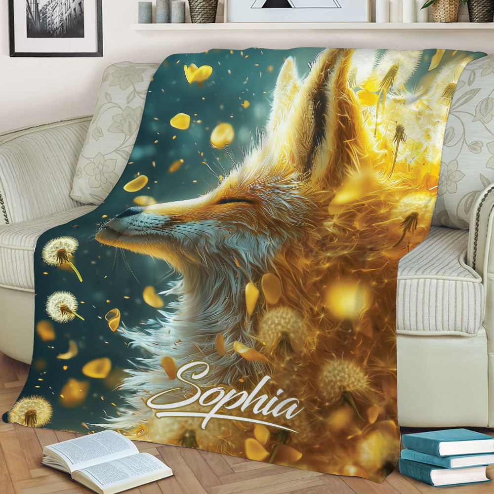 Fox throw blanket draped across a living room sofa with luminous dandelion and woodland artwork