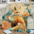 Decorative fox throw blanket displayed on a sofa with detailed flowers and foliage
