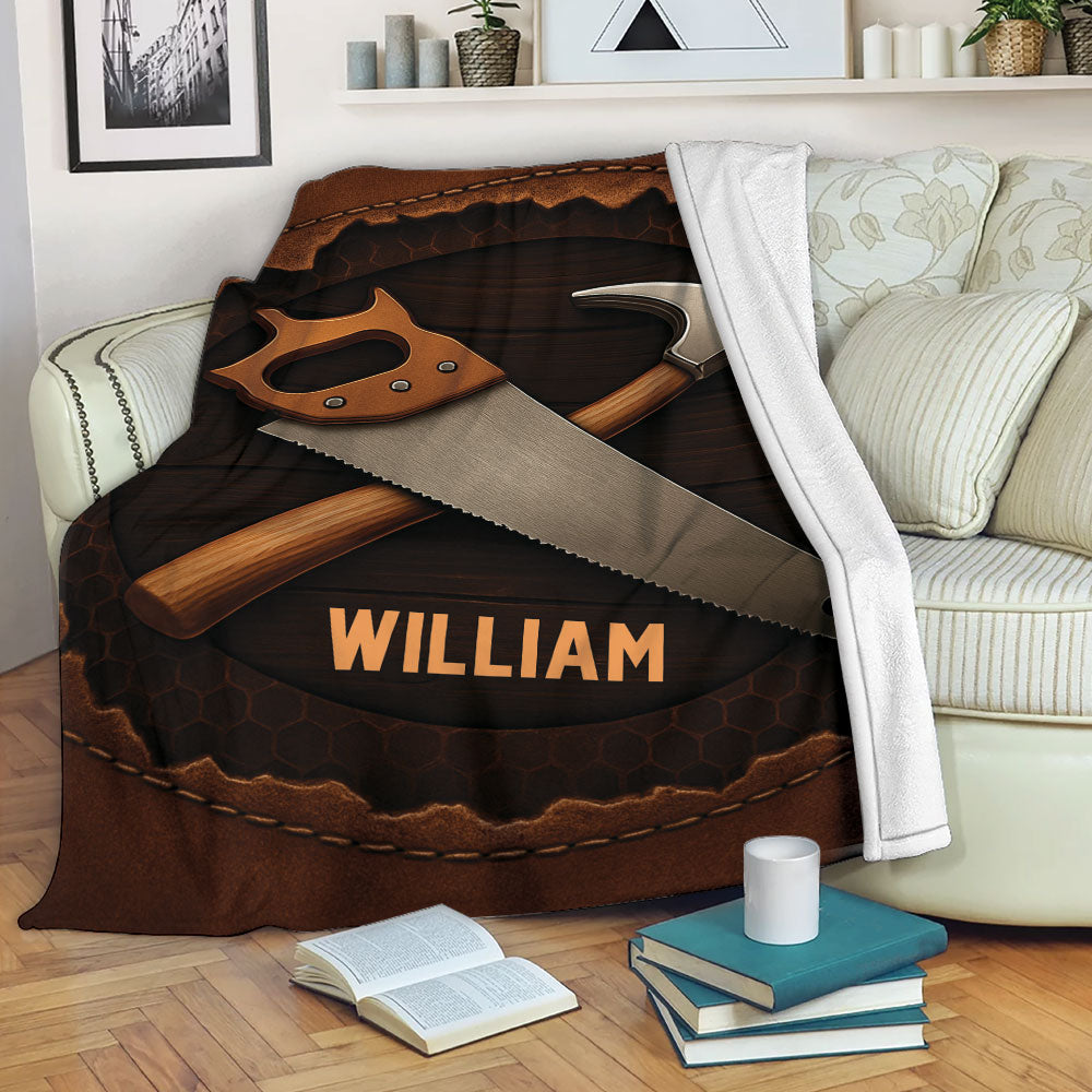 Carpenter blanket draped over a sofa with rustic hand saw and hammer artwork