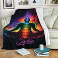 Yoga meditation throw blanket draped over a sofa with colorful chakra and galaxy artwork