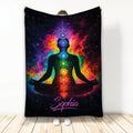 Yoga blanket with a meditating figure, colorful chakra symbols, and vivid cosmic rainbow artwork