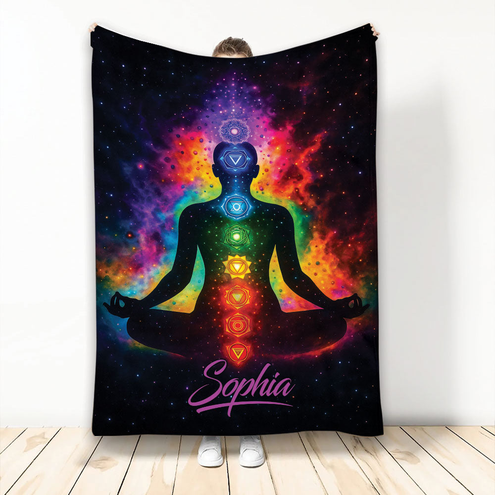 Yoga blanket with a meditating figure, colorful chakra symbols, and vivid cosmic rainbow artwork
