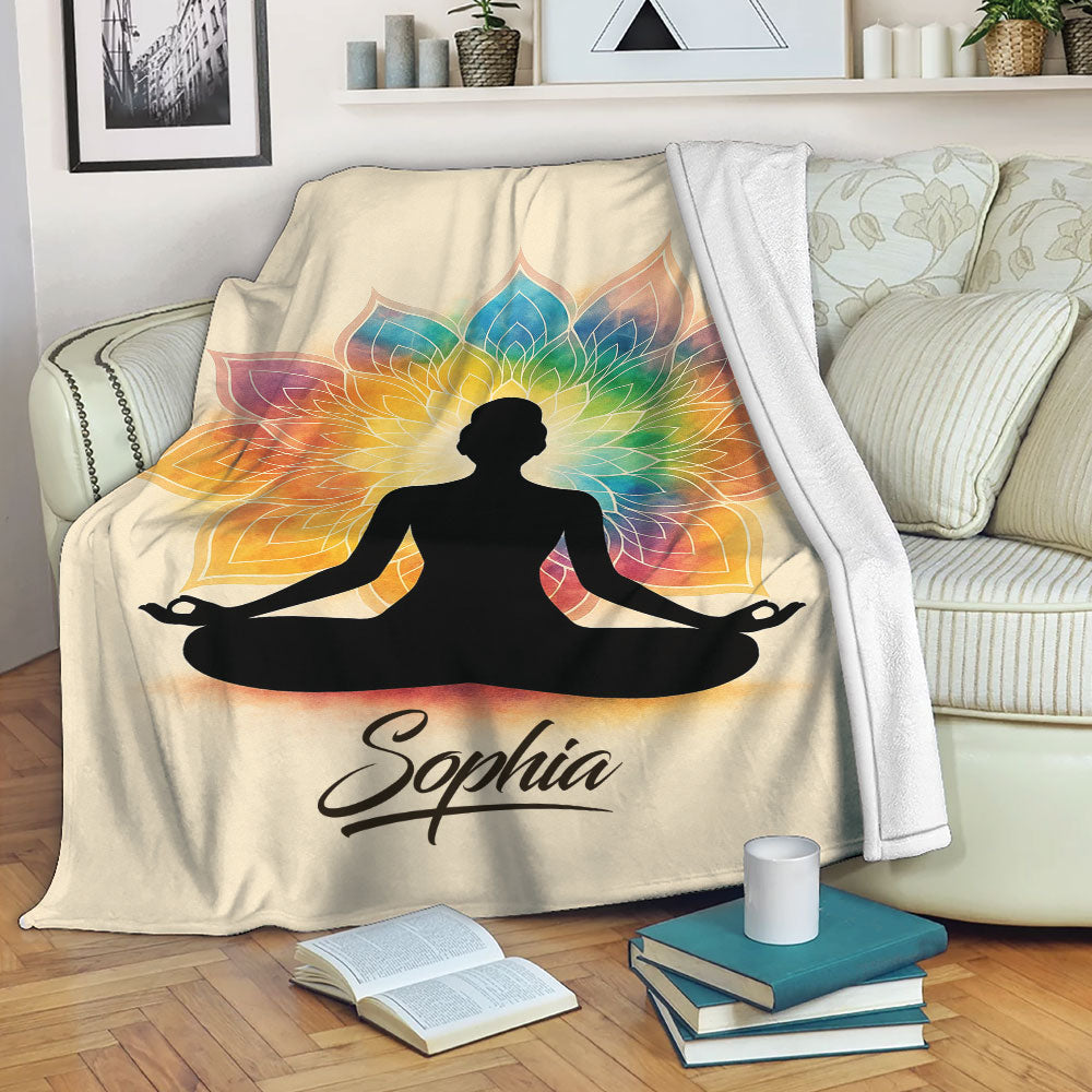 Colorful yoga meditation blanket displayed on a sofa with a vibrant mandala design