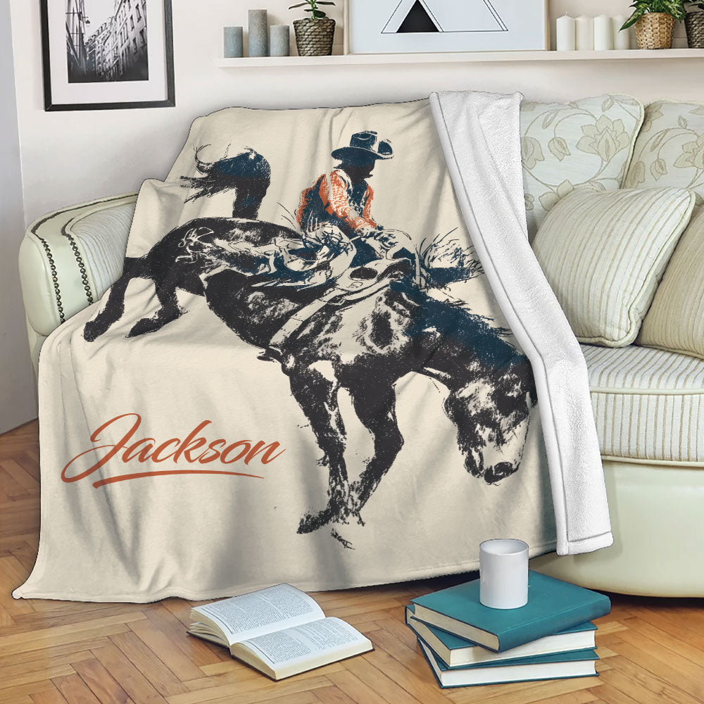 Custom rodeo blanket displayed on a sofa with vintage bull riding artwork