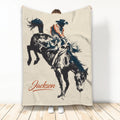 Rodeo throw blanket featuring a bull rider on a bucking bull in rustic western artwork