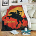 Rodeo throw blanket draped over a sofa with a cowboy and horse silhouette in bold western colors