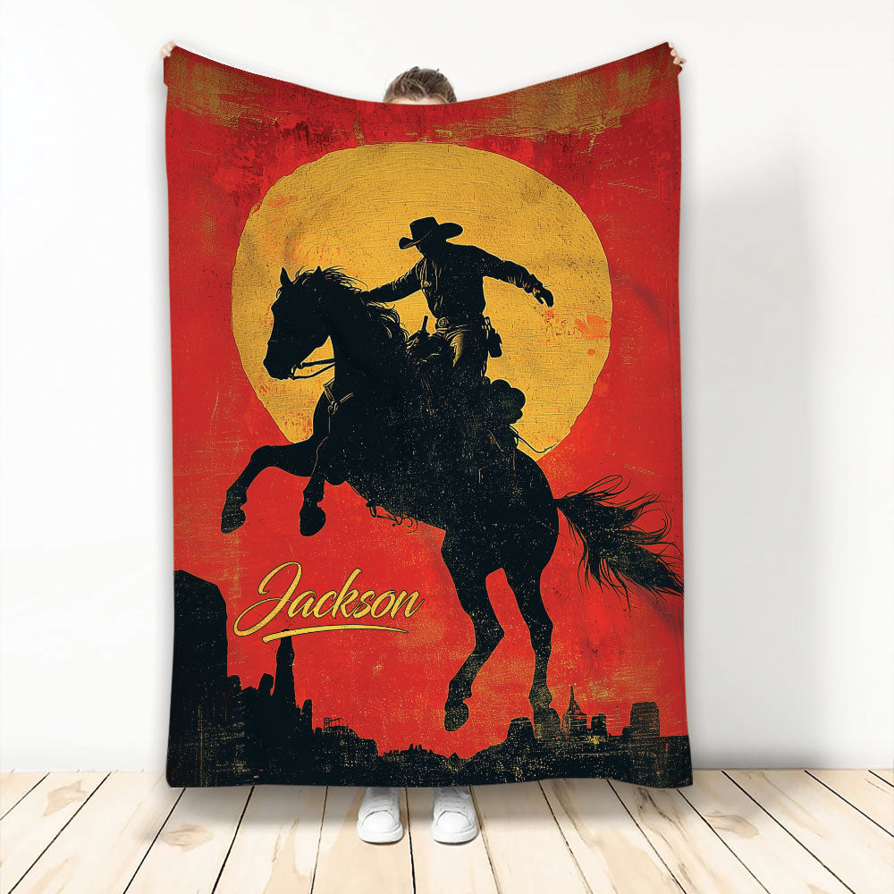 Rodeo blanket featuring a cowboy riding a rearing horse against a red and golden western sunset