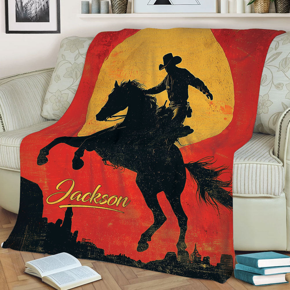 Close lifestyle view of a rodeo blanket with dramatic cowboy and horse artwork on a couch