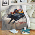 Rodeo bull riding throw blanket displayed across a cozy sofa in a living room