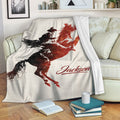 Rodeo bull riding blanket draped over a sofa with bold vintage western artwork