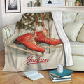 Ice skating throw blanket draped over a sofa with red skates and rustic winter artwork
