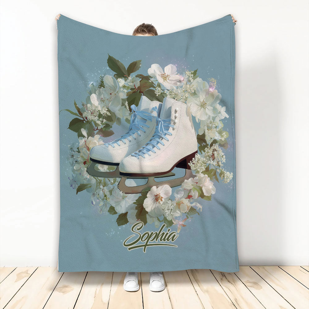 Ice skating blanket with white and blue skates surrounded by soft floral artwork