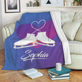 Ice skating throw blanket draped over a sofa with white skate artwork and heart design