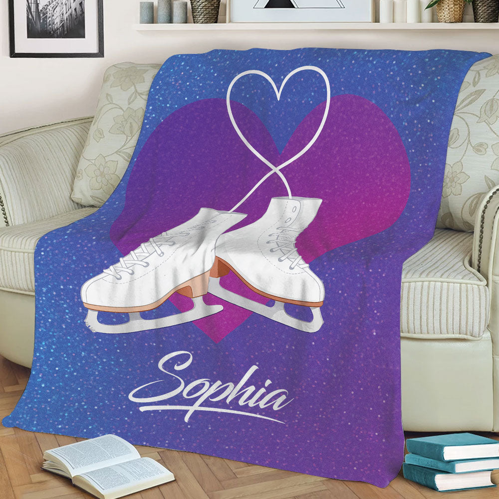 Blue and purple ice skating blanket displayed on a couch with crossed white skates