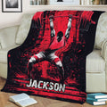 Weightlifting throw blanket draped over a sofa, featuring dramatic barbell strength training artwork