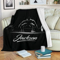Black weightlifting throw blanket draped over a sofa with white barbell lifting artwork