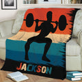Close view of weightlifting blanket featuring a barbell silhouette and colorful distressed stripe design