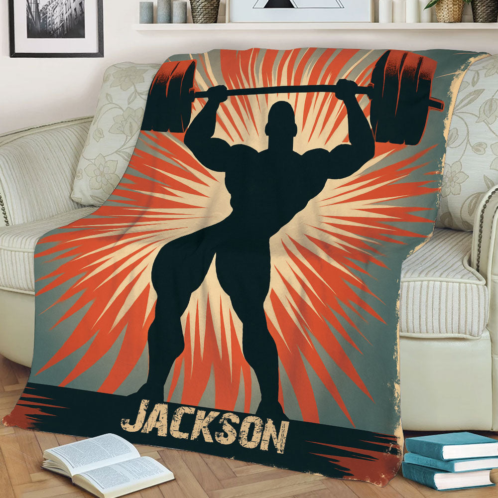 Close lifestyle view of a weightlifting throw blanket featuring a powerful barbell silhouette and retro athletic artwork