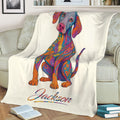Close view of a vibrant patterned Weimaraner blanket draped over a sofa