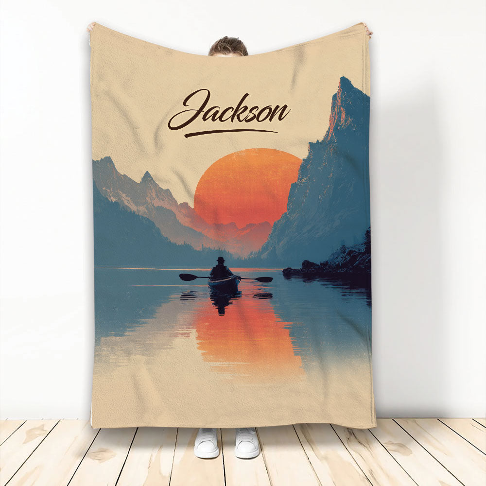 Kayak throw blanket with a mountain lake, sunset, and silhouetted paddler design