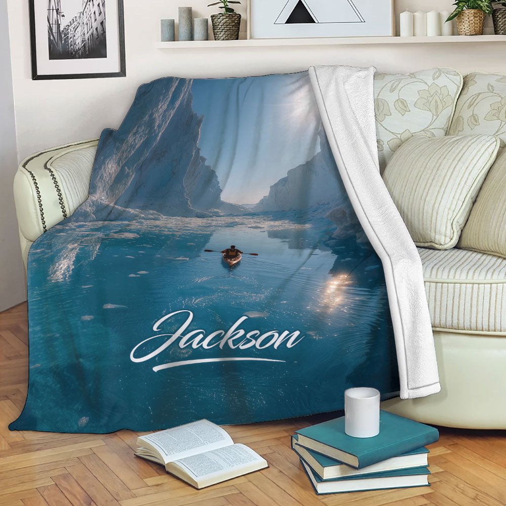 Kayak throw blanket draped over a sofa with blue water, ice cliffs and adventure artwork