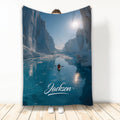 Kayak blanket featuring a blue icy canyon scene with a small kayaker on the water
