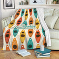 Colorful kayak throw blanket draped over a sofa in a cozy living room