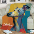 Vibrant illustrated Whippet blanket styled across a sofa with books nearby