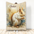 Illustrated squirrel blanket with floral woodland artwork displayed by a person