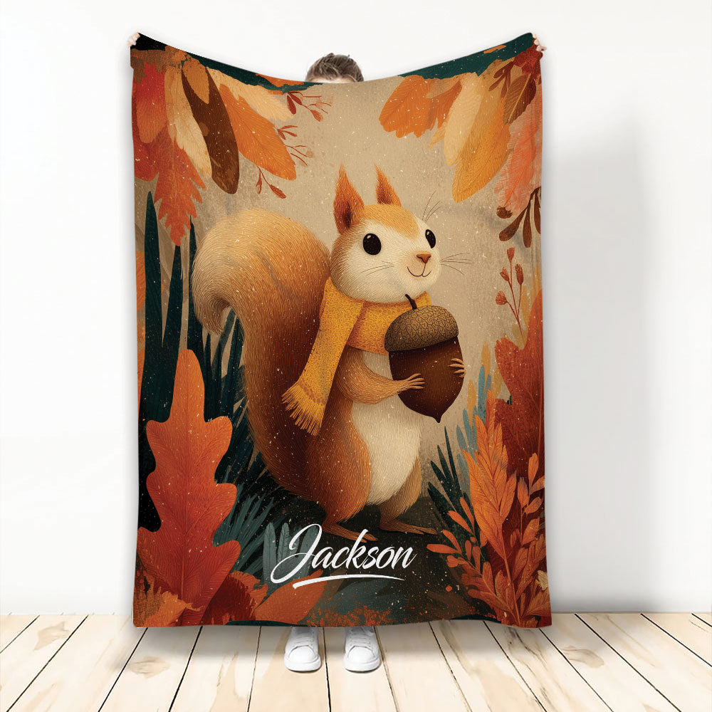 Autumn squirrel blanket design with an acorn, scarf, and colorful fall leaves