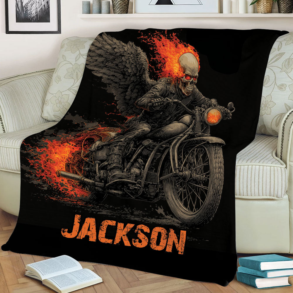 Motorcycle biker blanket draped over a couch with winged skull and flame artwork