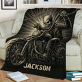 Black biker blanket draped over a sofa with detailed motorcycle and skull rider design