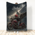 Biker throw blanket featuring a dramatic winged skull motorcycle rider beneath a stormy sky