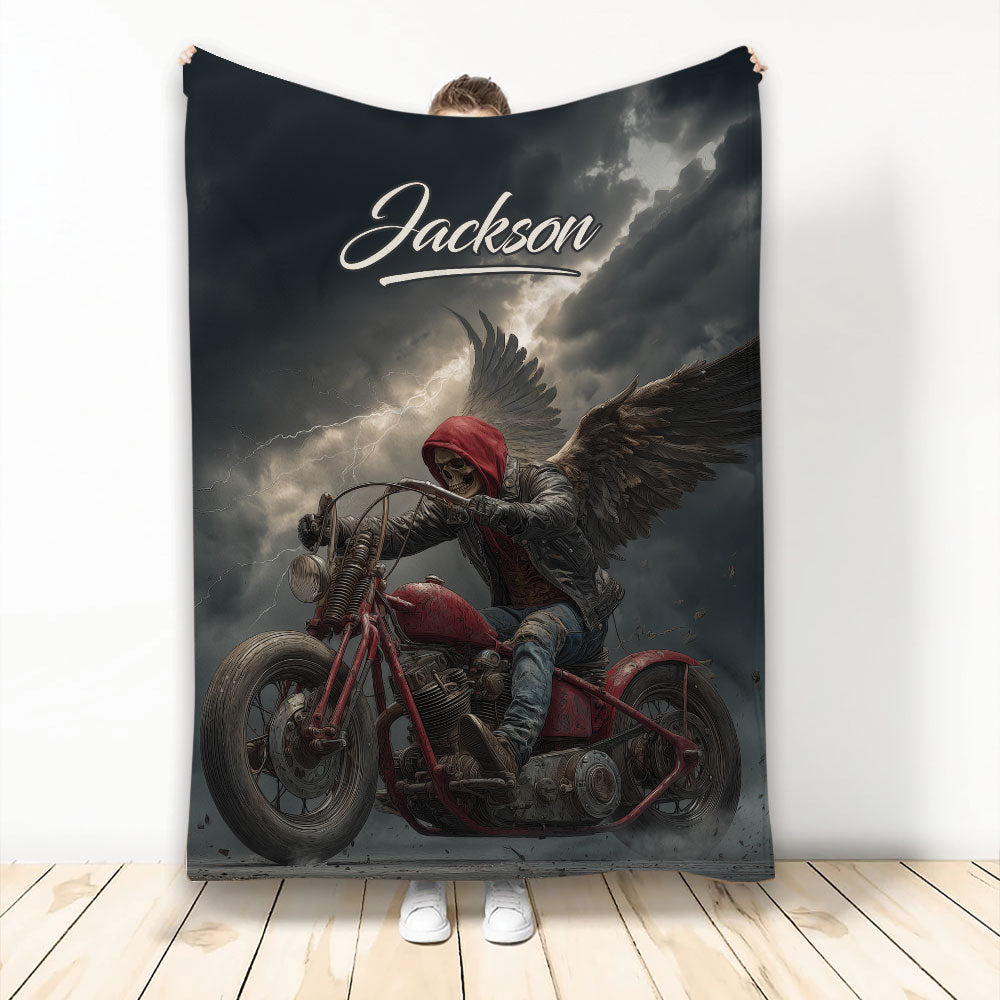 Biker throw blanket featuring a dramatic winged skull motorcycle rider beneath a stormy sky