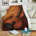 Violin blanket draped over a living room sofa with musical notes and warm wood-tone artwork