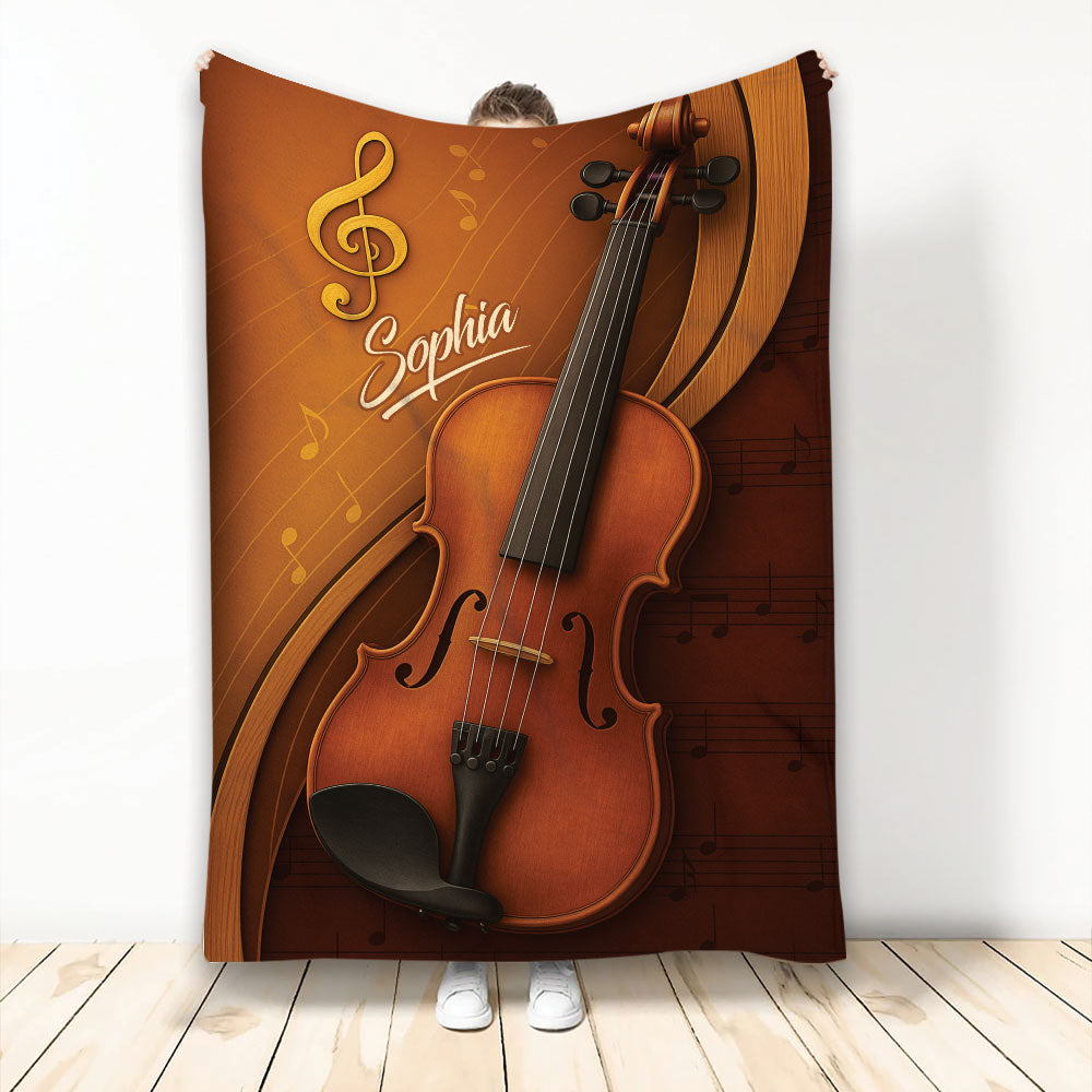 Violin throw blanket featuring warm amber artwork, musical notes, and a large string instrument design