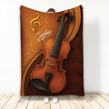 Violin throw blanket featuring warm amber artwork, musical notes, and a large string instrument design