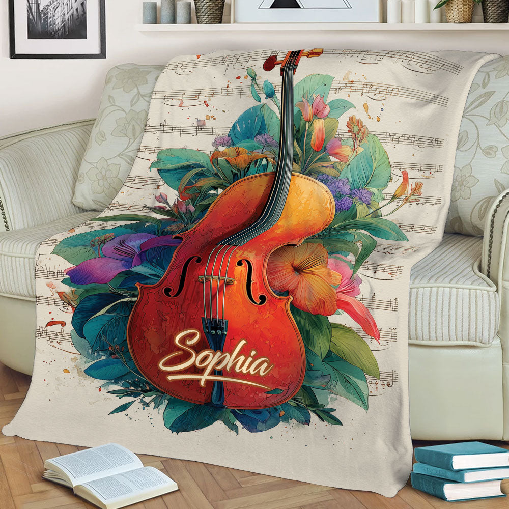 Close view of a colorful violin and flowers over musical notes on a decorative throw blanket